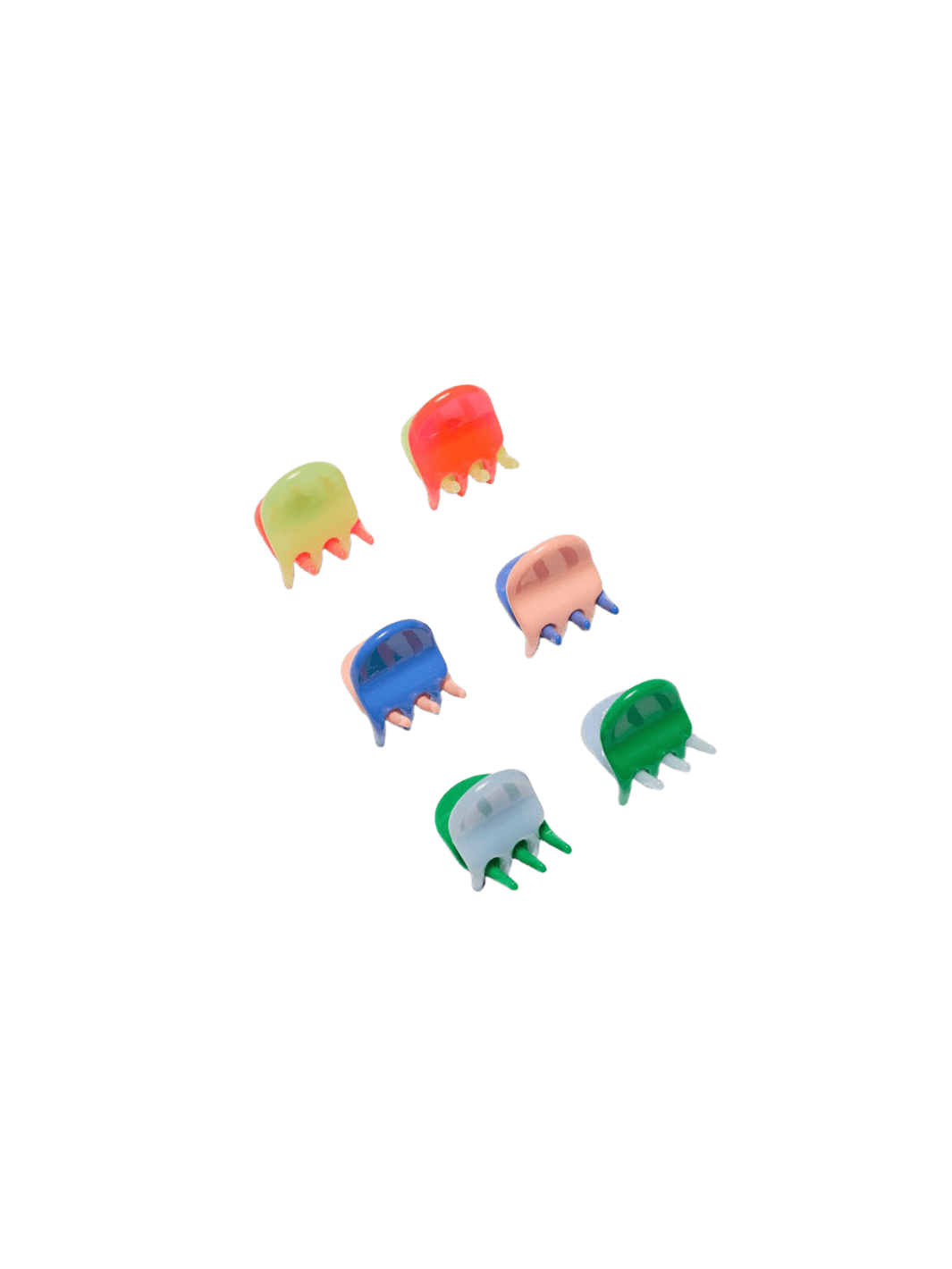 Six vibrant, translucent claw clips from the Chunks Hairclips Micro Claws in Play set are arranged neatly on a transparent surface | Twentyseven Toronto