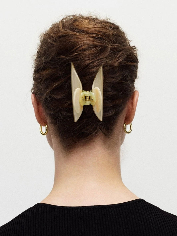 Woman with a claw hair clip from MACHETE in their hair on a white background | Twentyseven Toronto