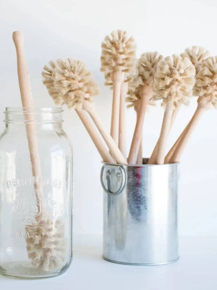 Set of natural milk bristle brushes in a metal container and glass jar from Burstenhaus Redecker on a white background | Twentyseven Toronto