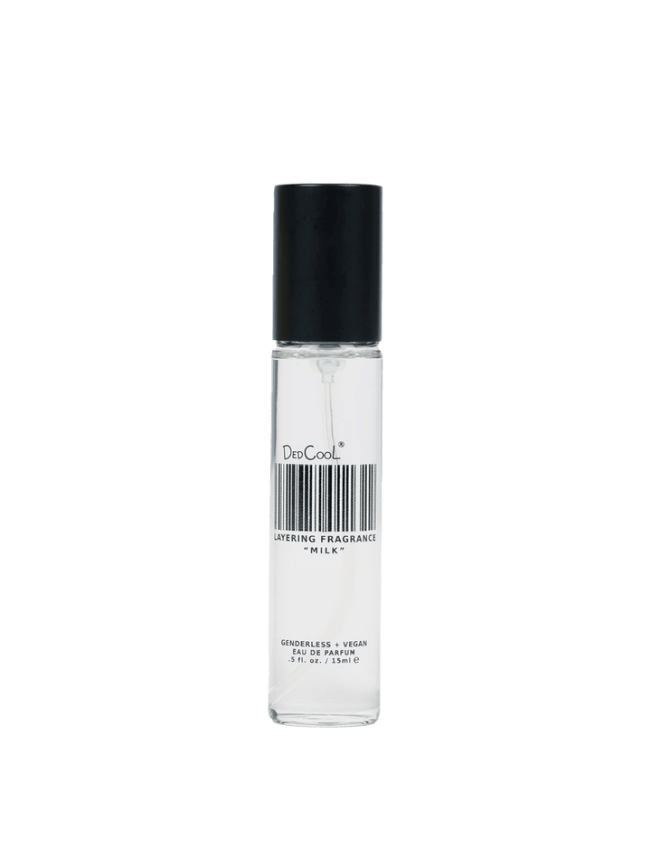 A 15ml travel sized bottle of Dedcool Milk Layering + Enhancer Fragrance with its signature barcode label and a black cap | Twentyseven Toronto