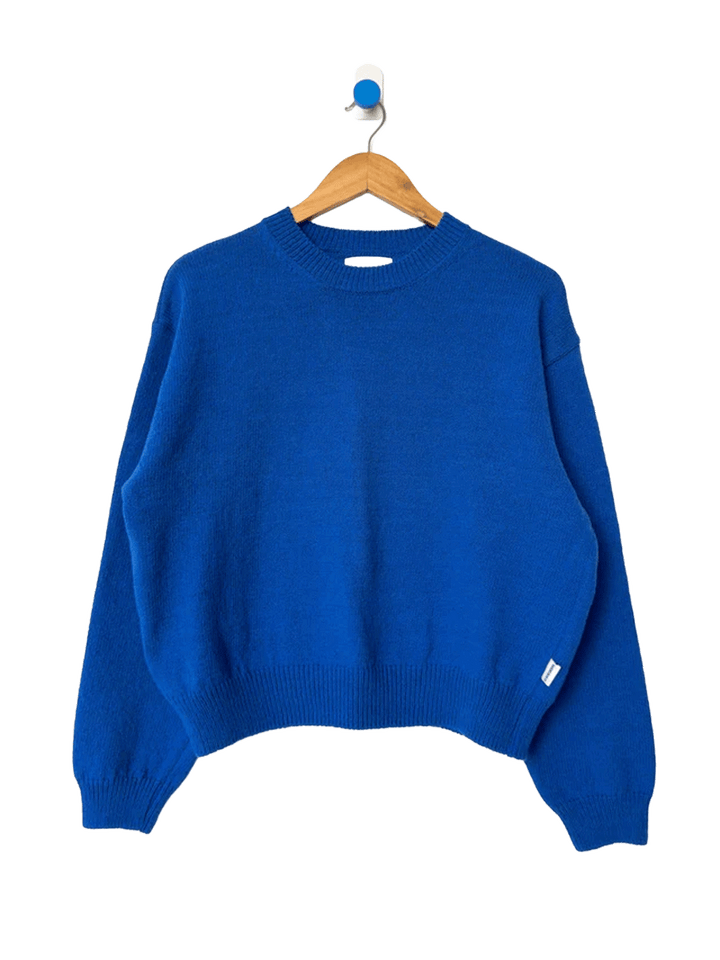 Le Bon Shoppe Milo Cotton Sweater in Cobalt Blue on a wooden hanger | Twentyseven Toronto