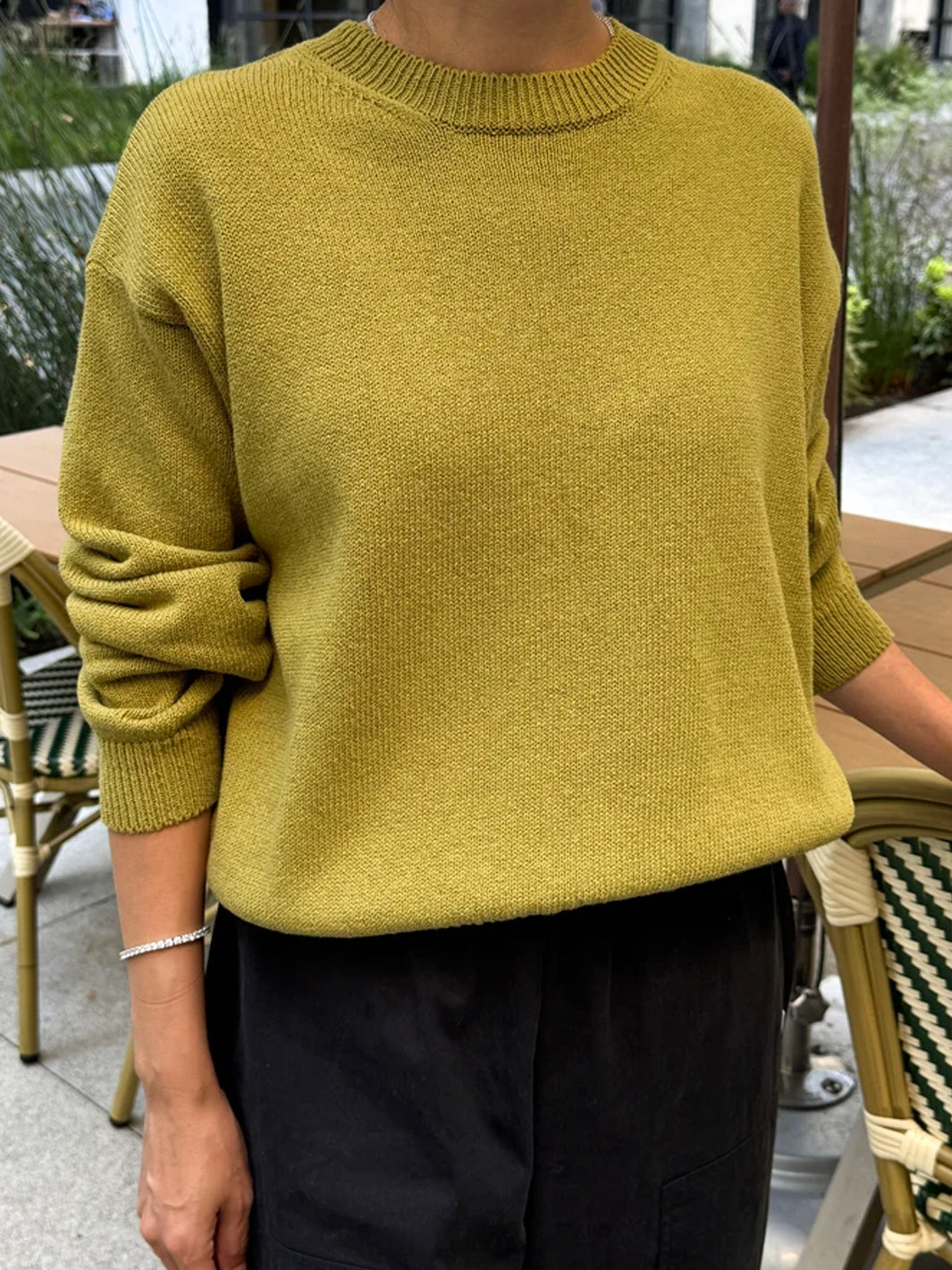 Front view of model wearing the Le Bon Shoppe Milo Cotton Sweater in Golden Olive with black pants | Twentyseven Toronto