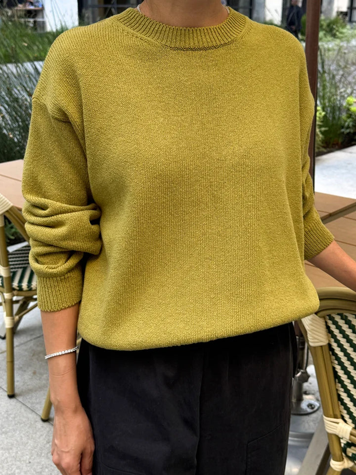 Front view of model wearing the Le Bon Shoppe Milo Cotton Sweater in Golden Olive with black pants | Twentyseven Toronto