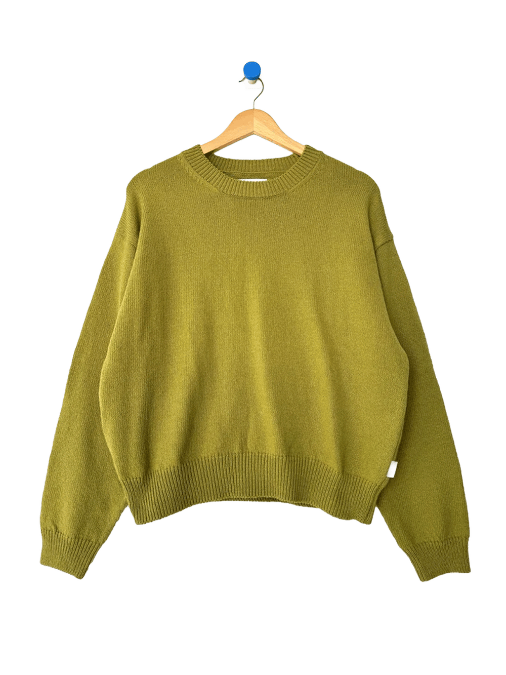 Le Bon Shoppe Milo Cotton Sweater in Golden Olive on a wooden hanger | Twentyseven Toronto