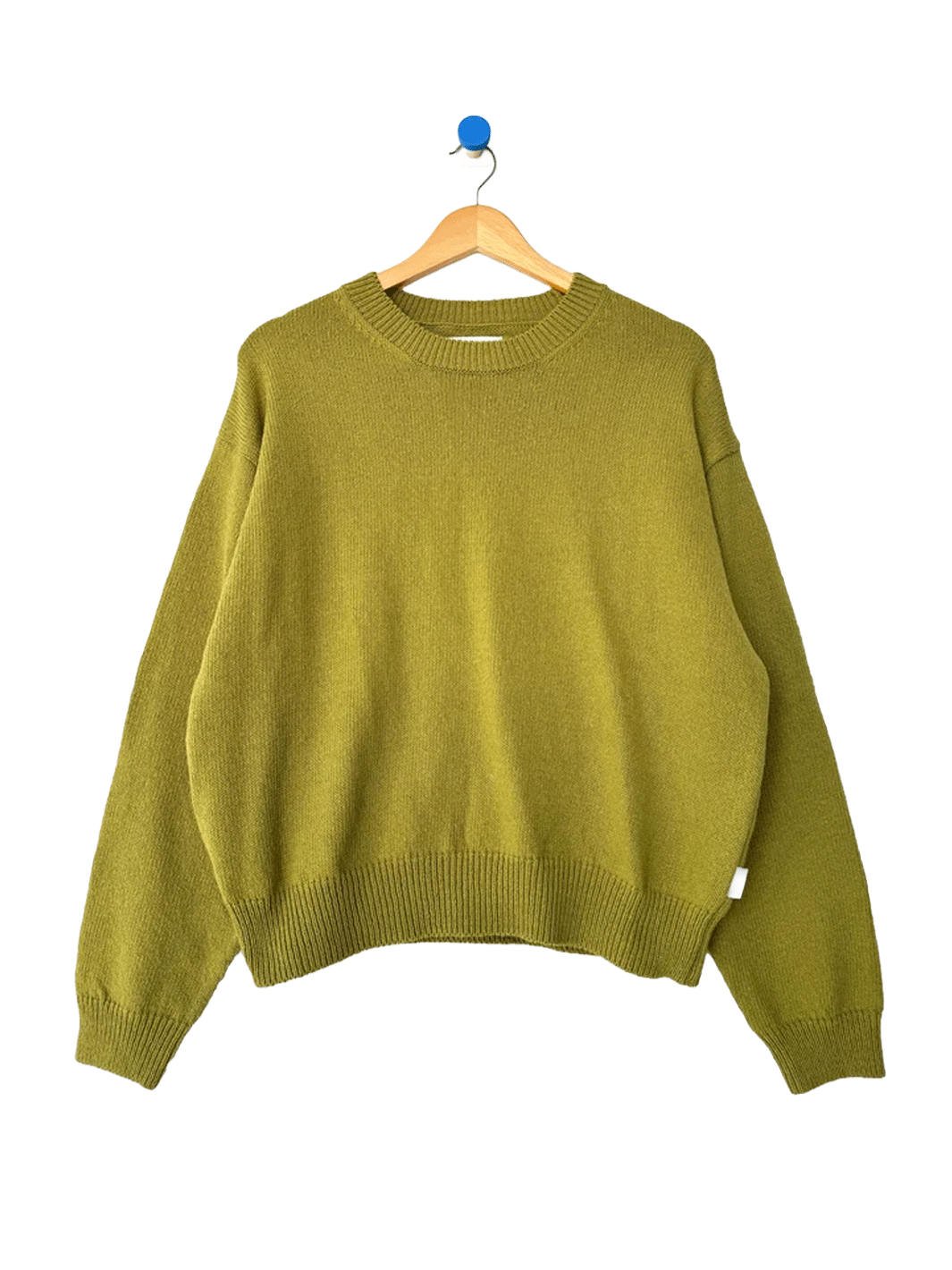 Le Bon Shoppe Milo Cotton Sweater in Golden Olive on a wooden hanger | Twentyseven Toronto