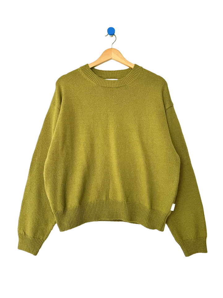 Le Bon Shoppe Milo Cotton Sweater in Golden Olive on a wooden hanger | Twentyseven Toronto
