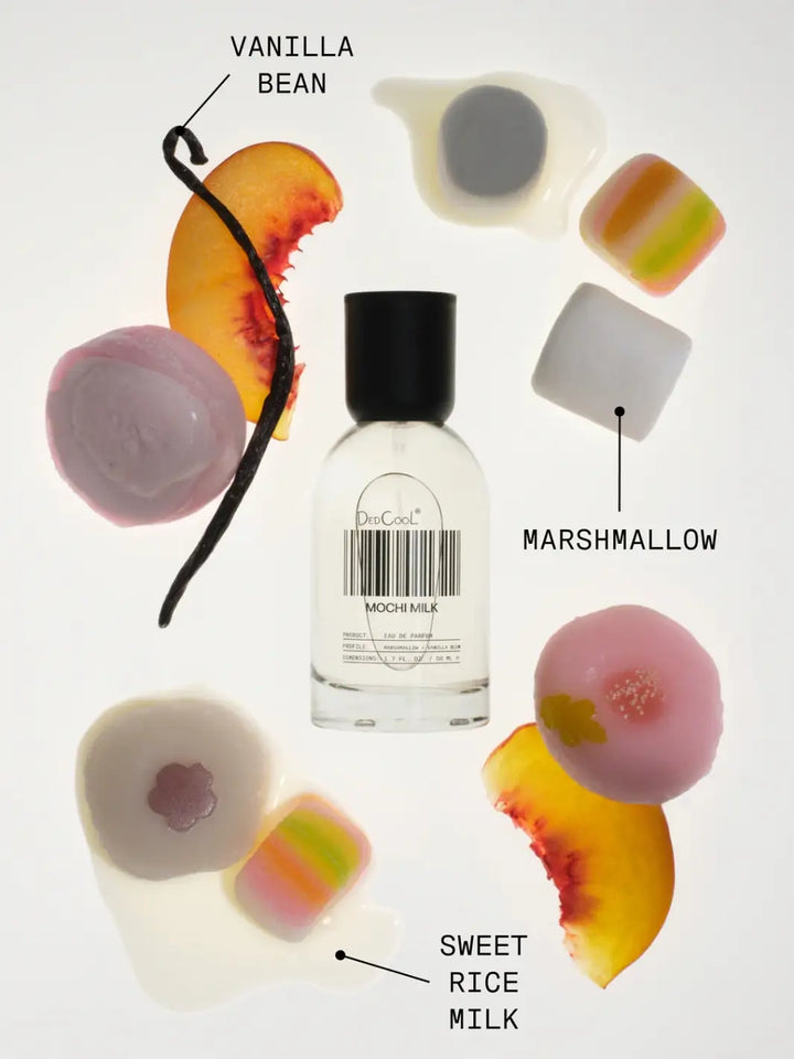 A 50 ml full size bottle of Dedcool Mochi Milk Fragrance floating among raw scent elements, including vanilla bean pods, peach slices, marshmallows, and pink mochi | Twentyseven Toronto