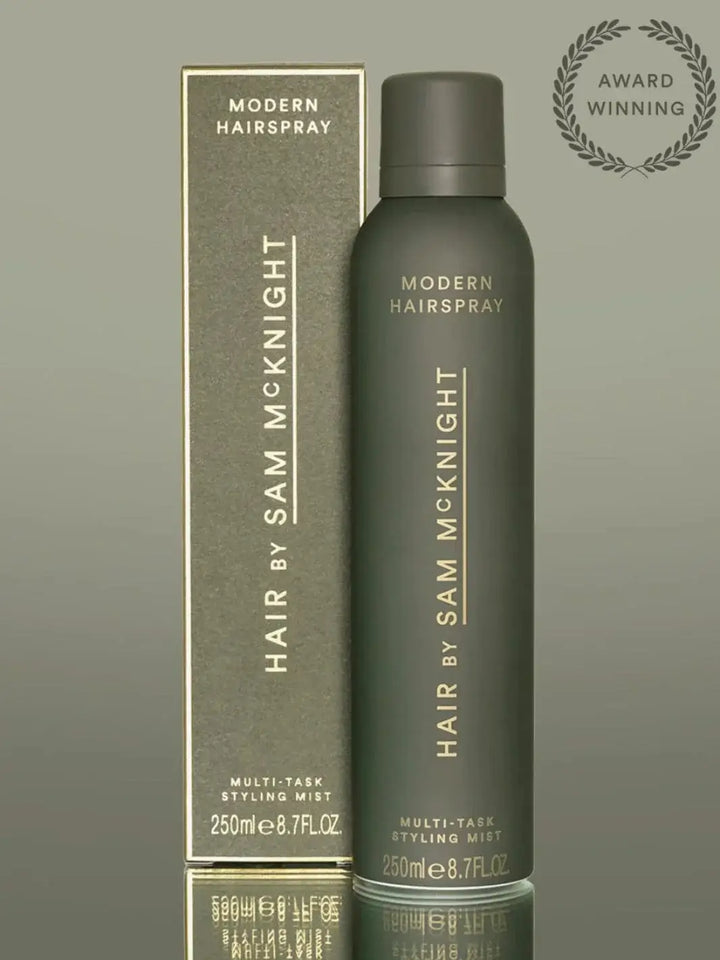 A product display features the green matte aerosol can next to its matching retail packaging for the Hair by Sam McKnight Modern Hairspray | Twentyseven Toronto