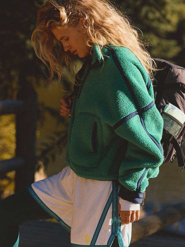 Side view of the FP Movement Mountain High Half-Zip Fleece in green, featuring contrast seams, zip pockets and a relaxed fit | Twentyseven Toronto