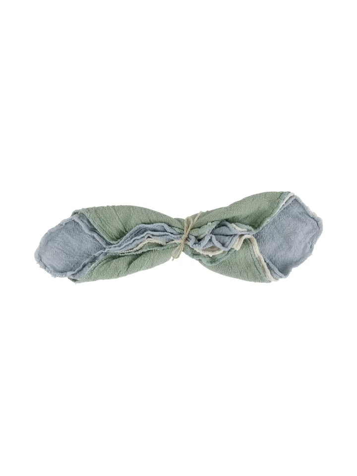 Three multi-purposed cotton towels tied up in green, beige, and gray from Burstenhaus Redecker on a white background | Twentyseven Toronto