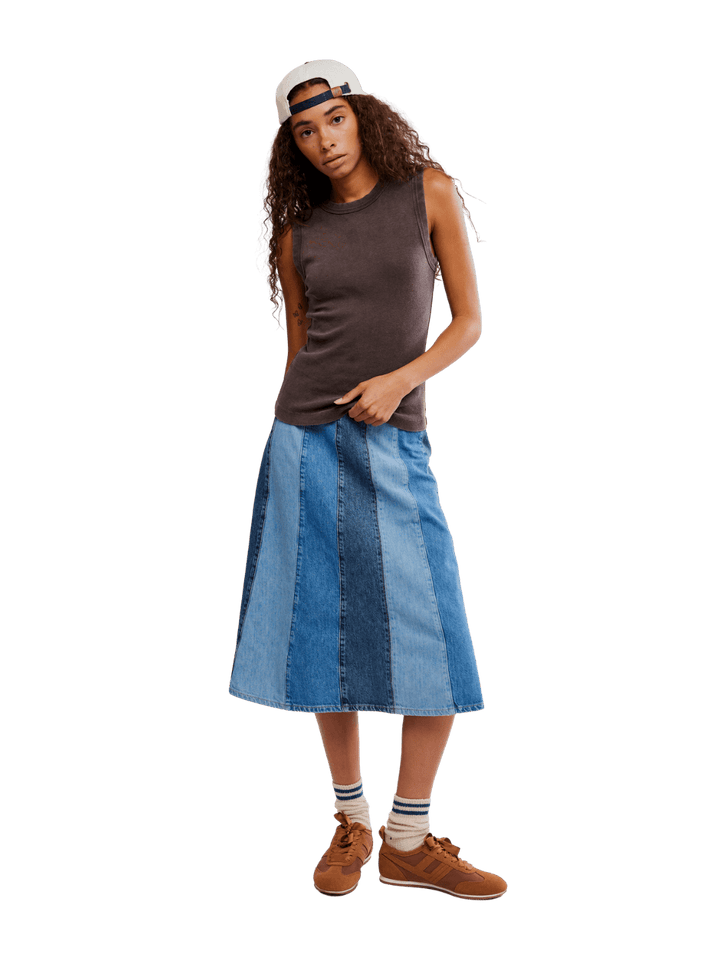 Woman wearing a brown 'Murphy Tank' top in Chocolatier and blue patchwork skirt from Free People on a transparent background | Twentyseven Toronto