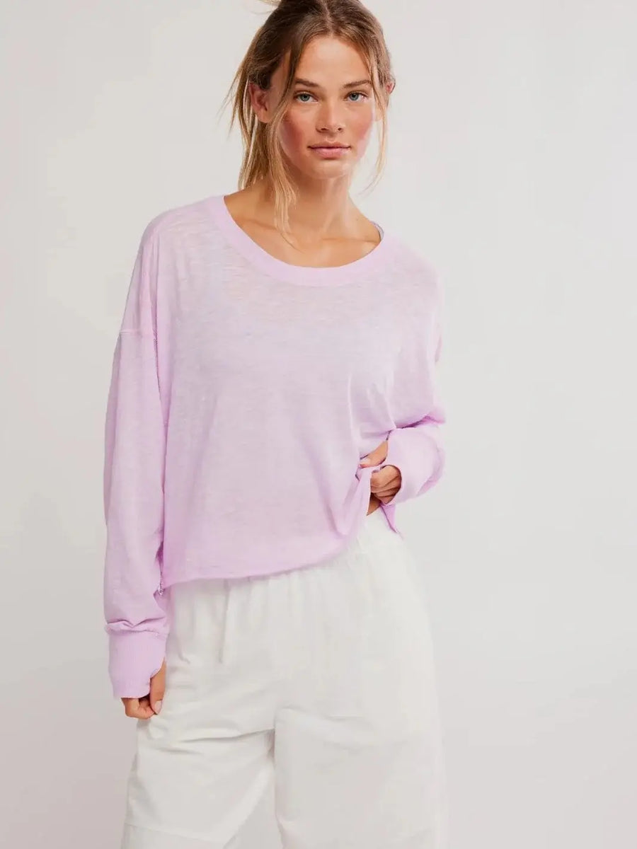 A front view shows a model wearing the relaxed-fit, crewneck Free People My Time Layer in Ultra Violet paired with white shorts | Twentyseven Toronto
