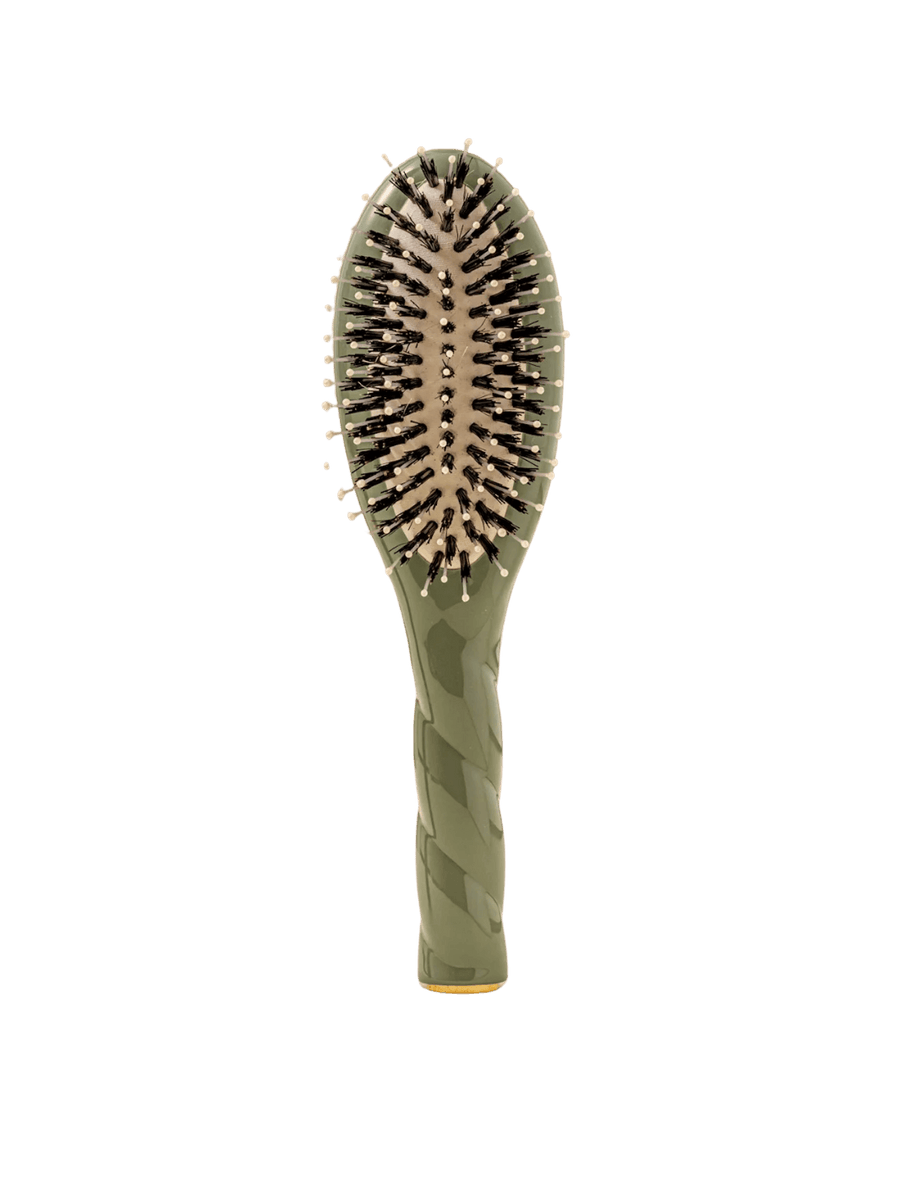 Front view of La Bonne Brosse N.03 Small The Essential Softness & Sensitive Scalp Brush in Almond Green featuring a twisted ergonomic handle and natural boar and nylon bristles | Twentyseven Toronto