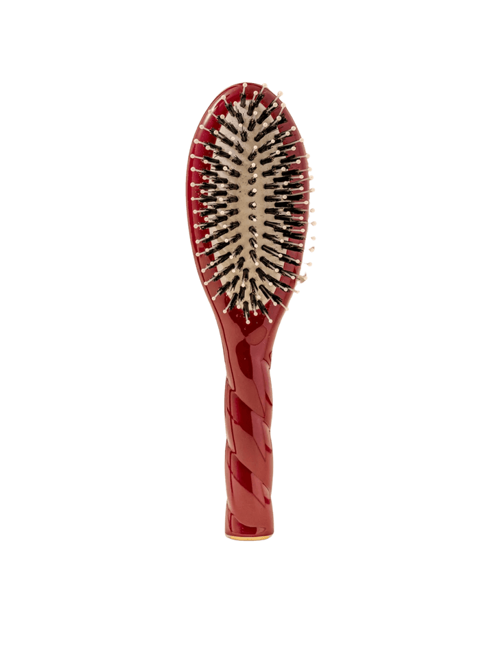 Front view of La Bonne Brosse N.03 Small The Essential Softness & Sensitive Scalp Brush in Cherry Red featuring a twisted ergonomic handle and natural boar and nylon bristles | Twentyseven Toronto