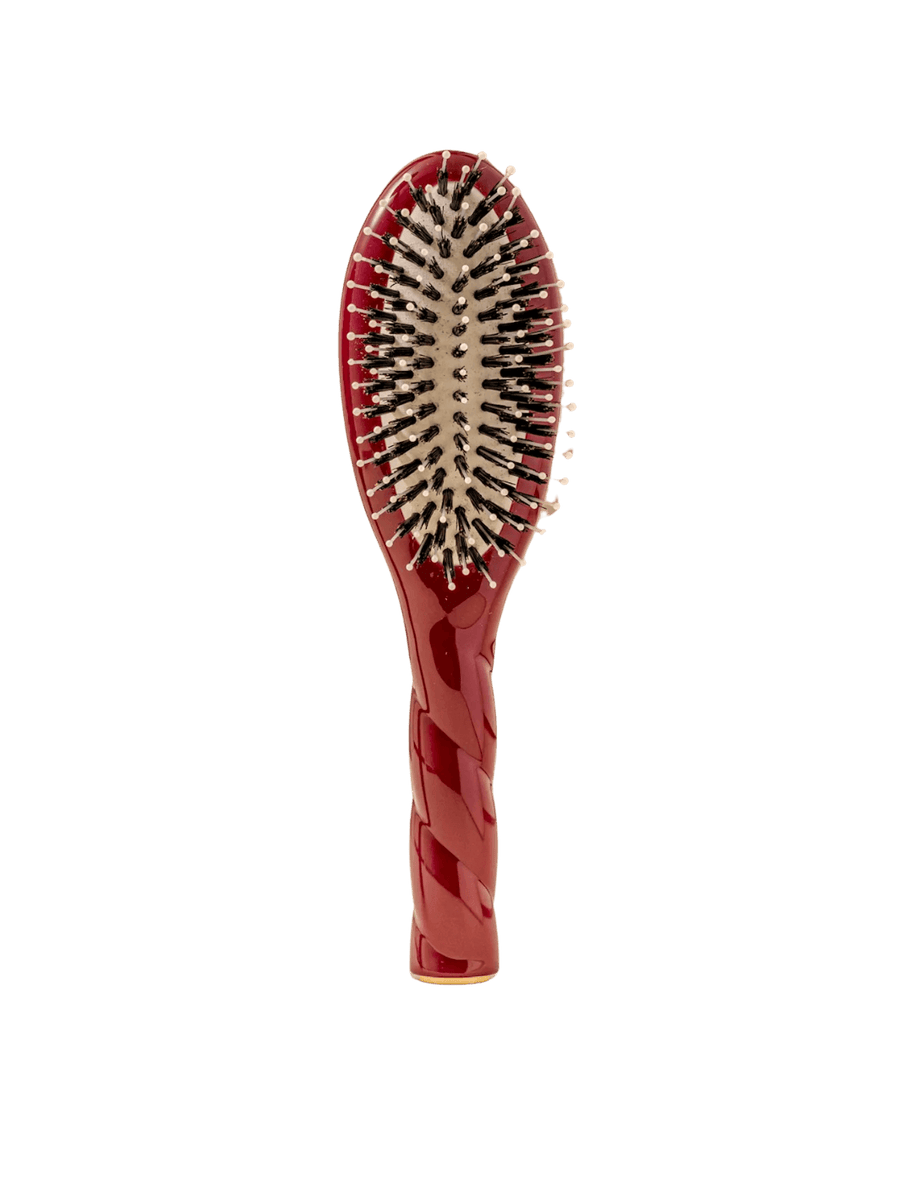 Front view of La Bonne Brosse N.03 Small The Essential Softness & Sensitive Scalp Brush in Cherry Red featuring a twisted ergonomic handle and natural boar and nylon bristles | Twentyseven Toronto
