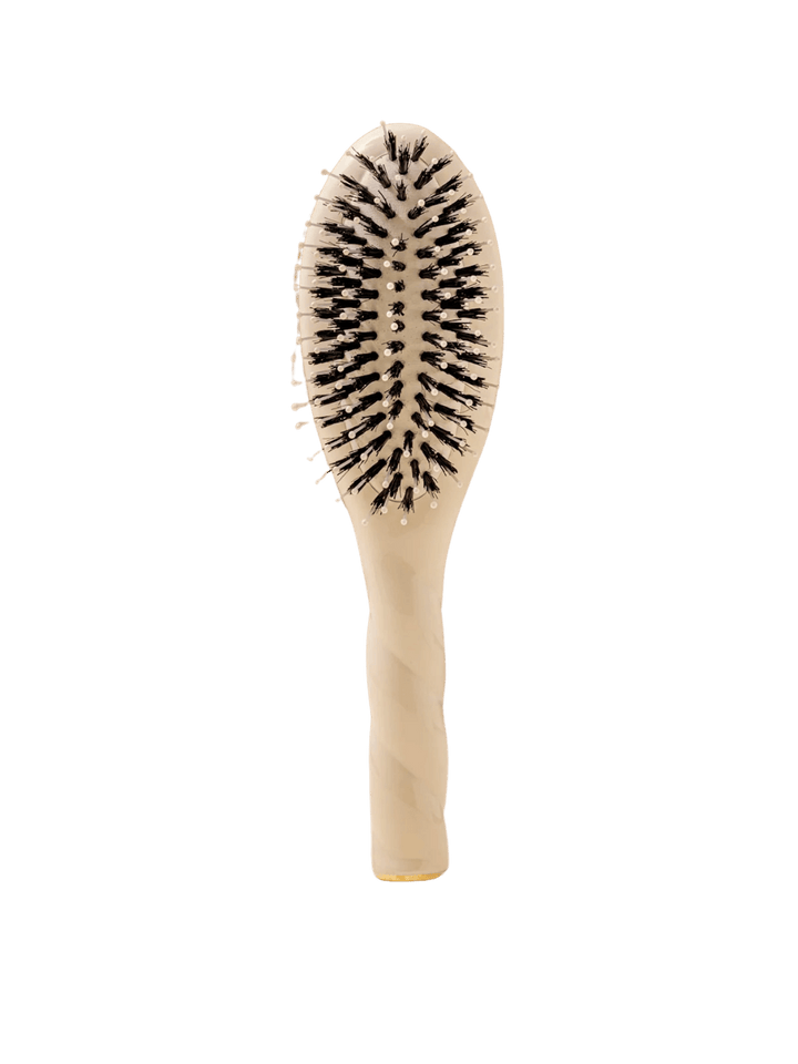 Front view of La Bonne Brosse N.03 Small The Essential Softness & Sensitive Scalp Brush in Creamy White featuring a twisted ergonomic handle and natural boar and nylon bristles | Twentyseven Toronto