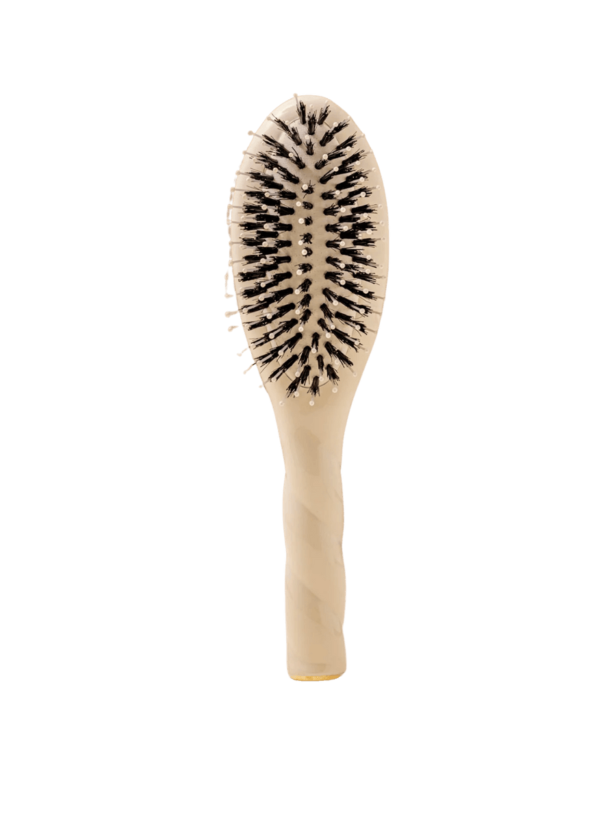 Front view of La Bonne Brosse N.03 Small The Essential Softness & Sensitive Scalp Brush in Creamy White featuring a twisted ergonomic handle and natural boar and nylon bristles | Twentyseven Toronto