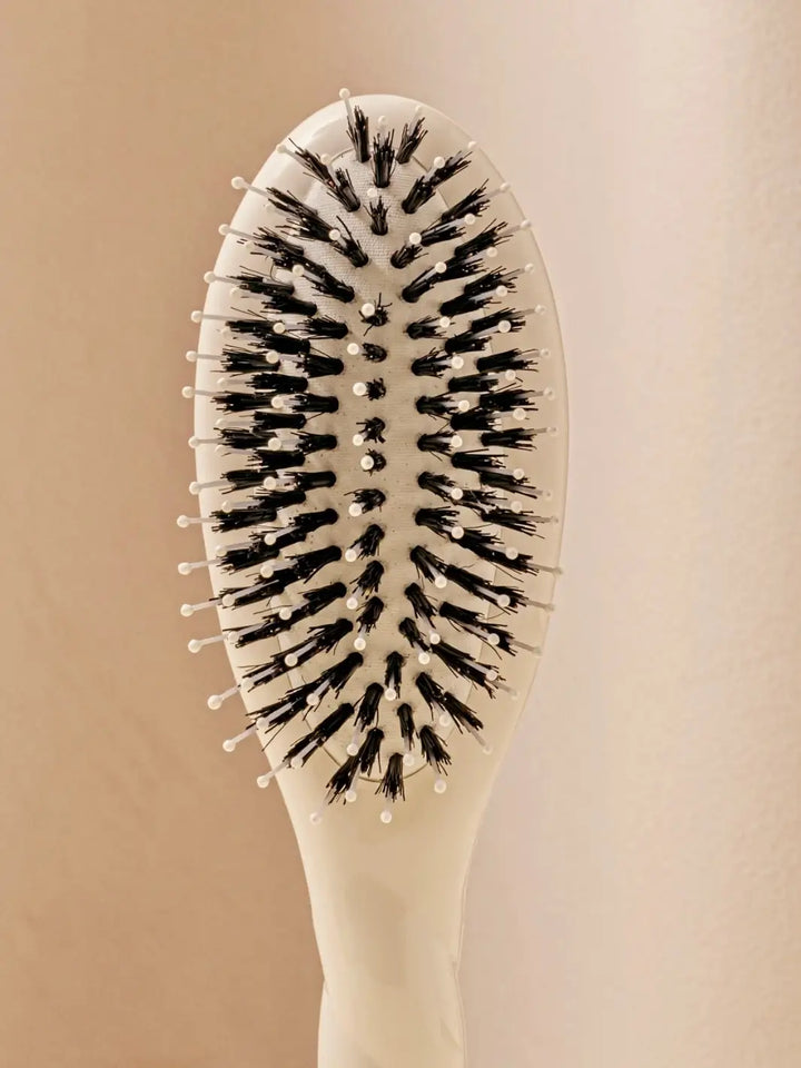 Front shot of the oval head and high-quality tufts of La Bonne Brosse N.03 Small The Essential Softness & Sensitive Scalp Brush in Creamy White | Twentyseven Toronto