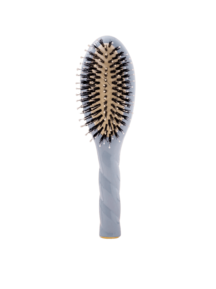 Front view of La Bonne Brosse N.03 Small The Essential Softness & Sensitive Scalp Brush in Light Blue featuring a twisted ergonomic handle and natural boar and nylon bristles | Twentyseven Toronto
