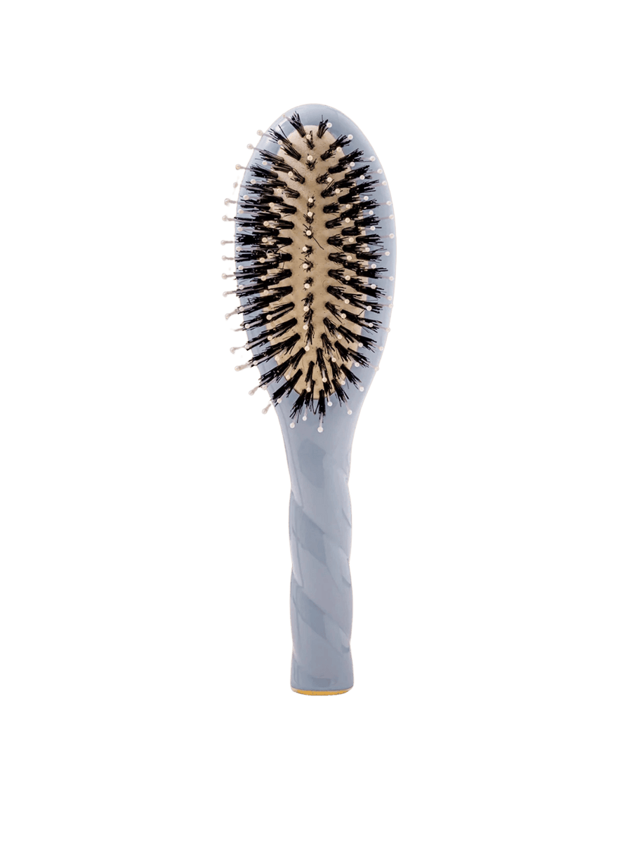 Front view of La Bonne Brosse N.03 Small The Essential Softness & Sensitive Scalp Brush in Light Blue featuring a twisted ergonomic handle and natural boar and nylon bristles | Twentyseven Toronto