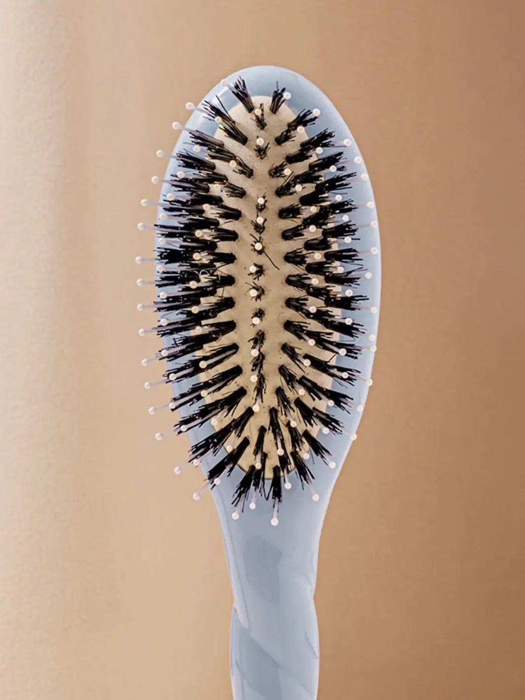 Front shot of the oval head and high-quality tufts of La Bonne Brosse N.03 Small The Essential Softness & Sensitive Scalp Brush in Light Blue | Twentyseven Toronto