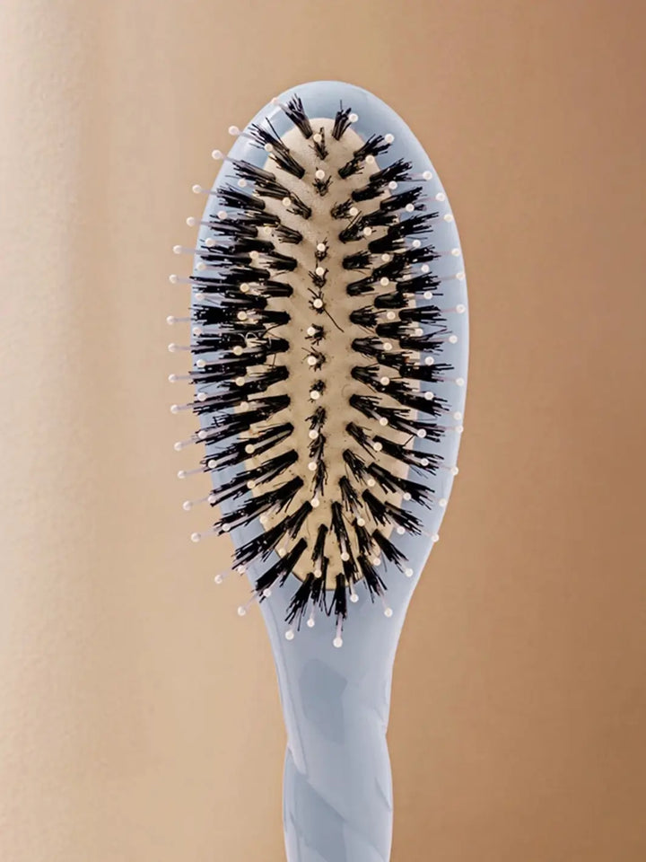 Front shot of the oval head and high-quality tufts of La Bonne Brosse N.03 Small The Essential Softness & Sensitive Scalp Brush in Light Blue | Twentyseven Toronto