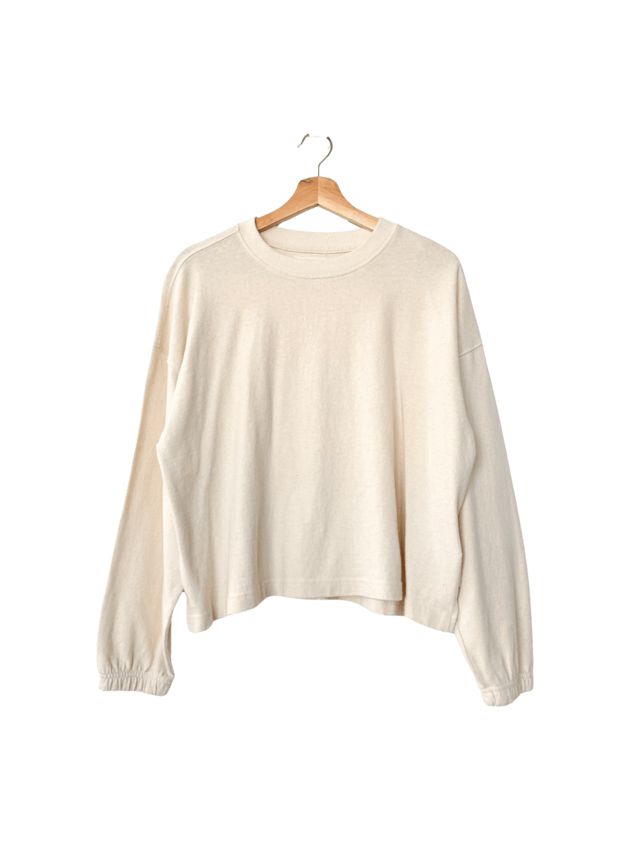 Cream 'Naturelle Tee' sweater in 'Naturel' from Le Bon Shoppe on a wooden hanger | Twentyseven Toronto
