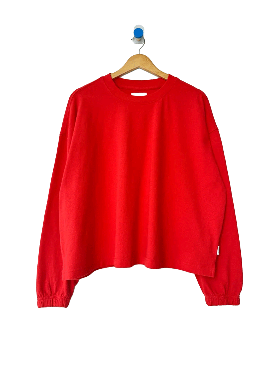 Le Bon Shoppe Naturelle Tee in Tomato on a wooden hanger against a white background | Twentyseven Toronto