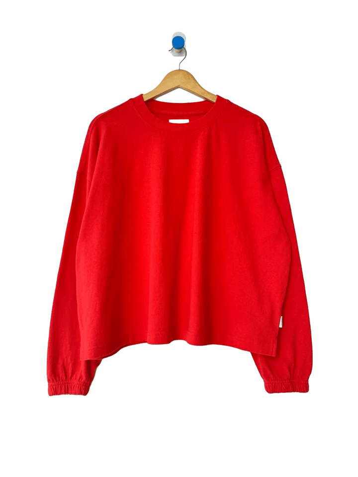 Le Bon Shoppe Naturelle Tee in Tomato on a wooden hanger against a white background | Twentyseven Toronto
