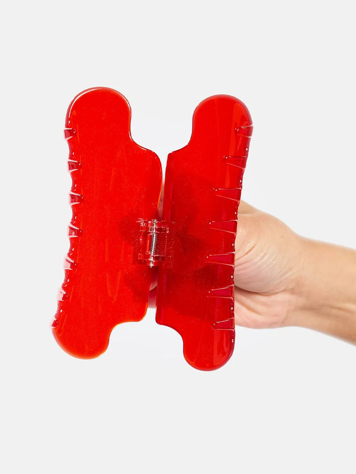 Chunks Nimbus Claw in Candy Red held open to show its wide shape, curved teeth, and spring hinge | Twentyseven Toronto