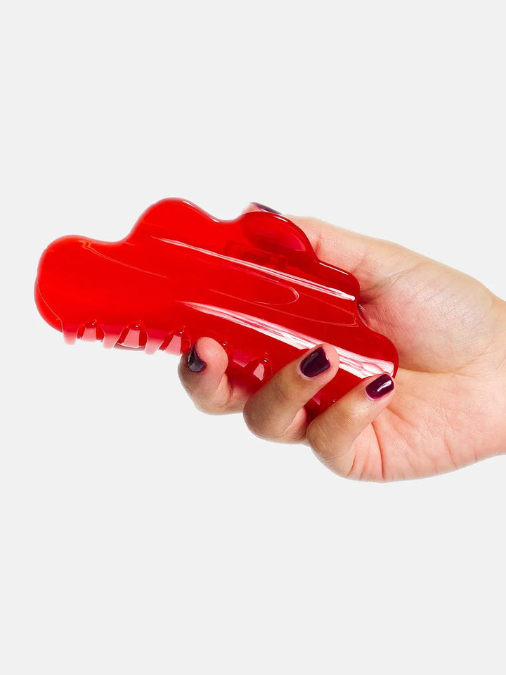 Chunks Nimbus Claw in Candy Red held in hand to show its oversized shape and translucent red finish | Twentyseven Toronto