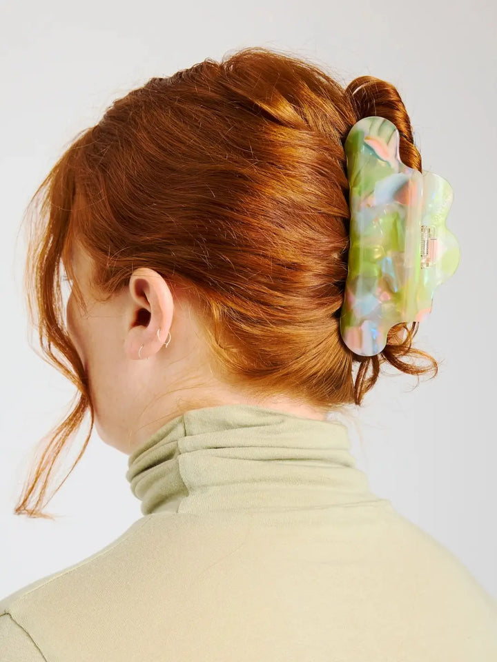 A model with red hair styled in a high bun secures her updo with the pastel-swirled CHUNKS Nimbus Claw Clip in Sherbet Jelly | Twentyseven Toronto
