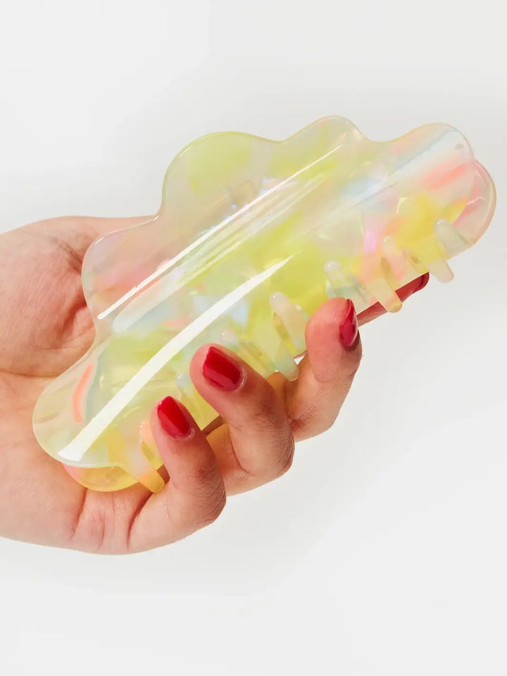 A hand with red fingernails holds the CHUNKS Nimbus Claw Clip in Sherbet Jelly to demonstrate the size and wavy silhouette of the hair accessory | Twentyseven Toronto