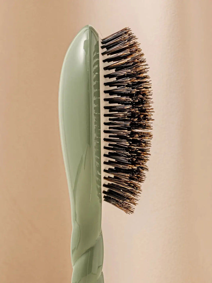 Close-up side profile shot highlights the tiered bristle design of La Bonne Brosse N.01 The Shine & Care Hairbrush The Universal Brush in Almond Green | Twentyseven Toronto