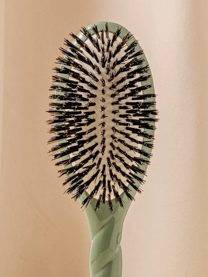 Front shot of the oval head and high-quality tufts of La Bonne Brosse N.01 The Shine & Care Hairbrush The Universal Brush in Almond Green | Twentyseven Toronto