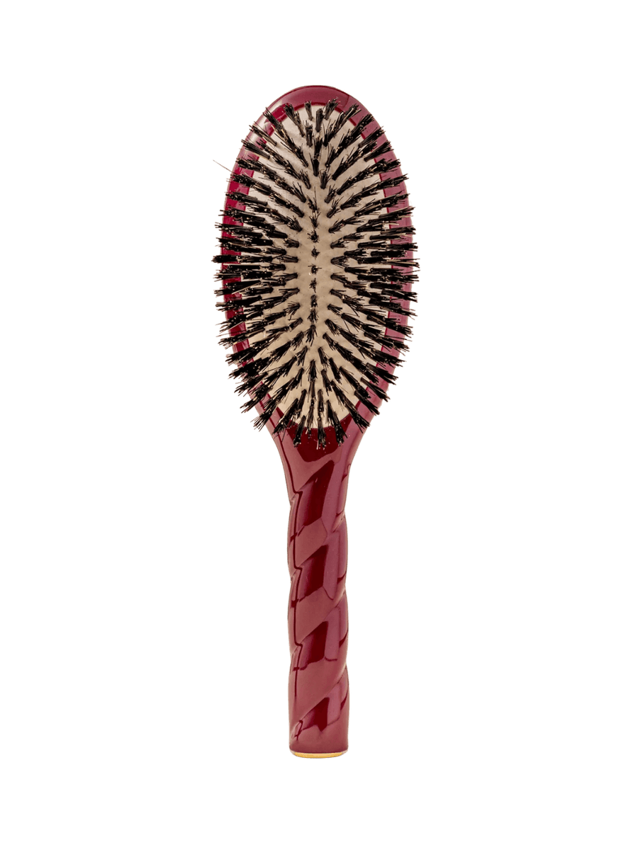 Front view of La Bonne Brosse N.01 The Shine & Care Hairbrush The Universal Brush in Cherry Red featuring a twisted ergonomic handle and natural boar bristles | Twentyseven Toronto