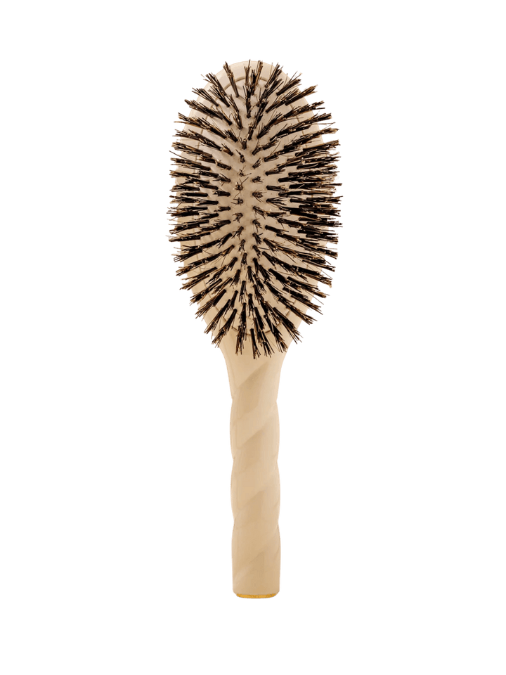 Front view of La Bonne Brosse N.01 The Shine & Care Hairbrush The Universal Brush in Creamy White featuring a twisted ergonomic handle and natural boar bristles | Twentyseven Toronto