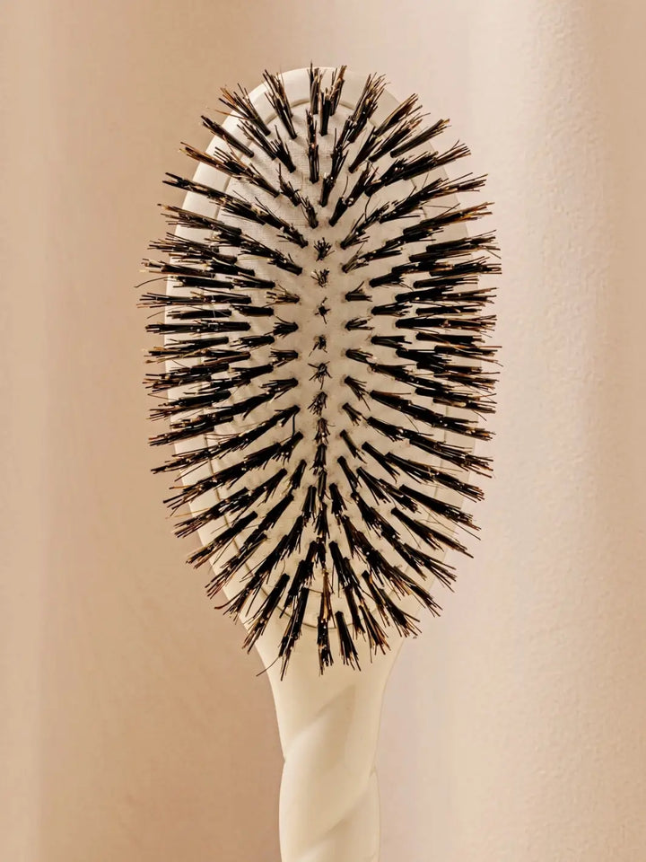Front shot of the oval head and high-quality tufts of La Bonne Brosse N.01 The Shine & Care Hairbrush The Universal Brush in Creamy White | Twentyseven Toronto