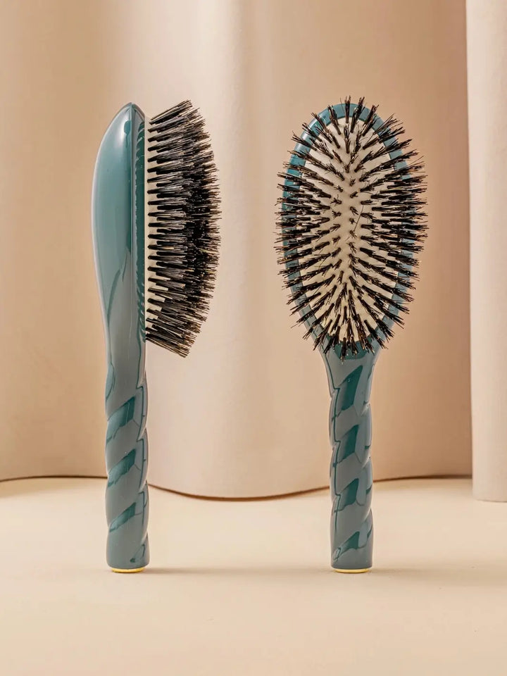 Side and front views of La Bonne Brosse N.01 The Shine & Care Hairbrush The Universal Brush in Ink Blue standing against a neutral background | Twentyseven Toronto
