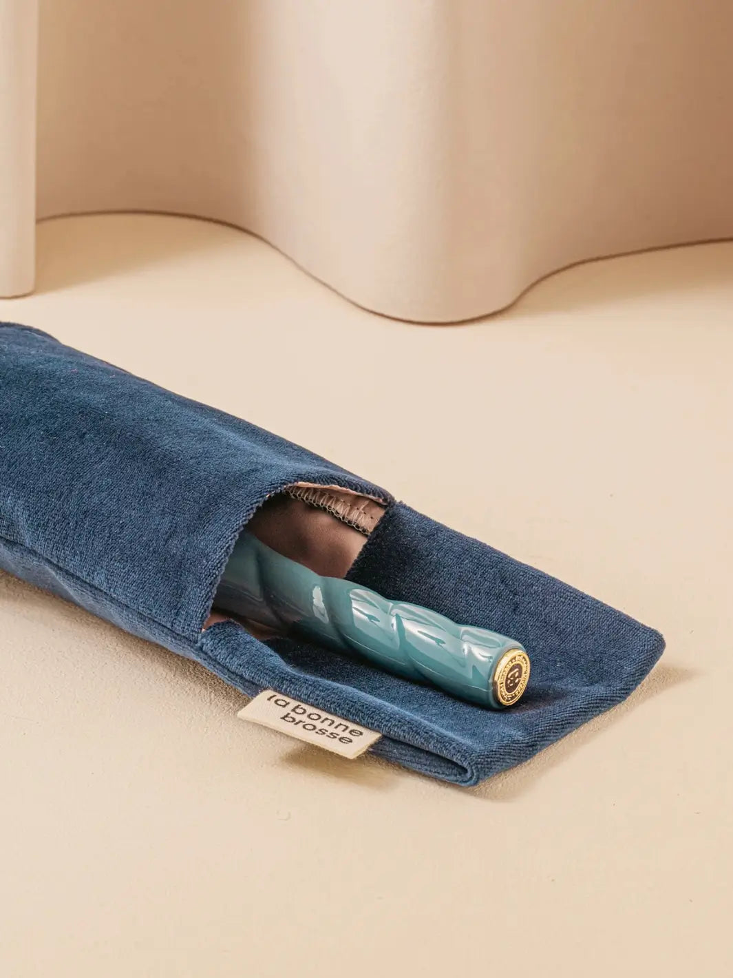 La Bonne Brosse N.01 The Shine & Care Hairbrush The Universal Brush in Ink Blue is shown partially tucked into its matching blue velvet protection pouch | Twentyseven Toronto