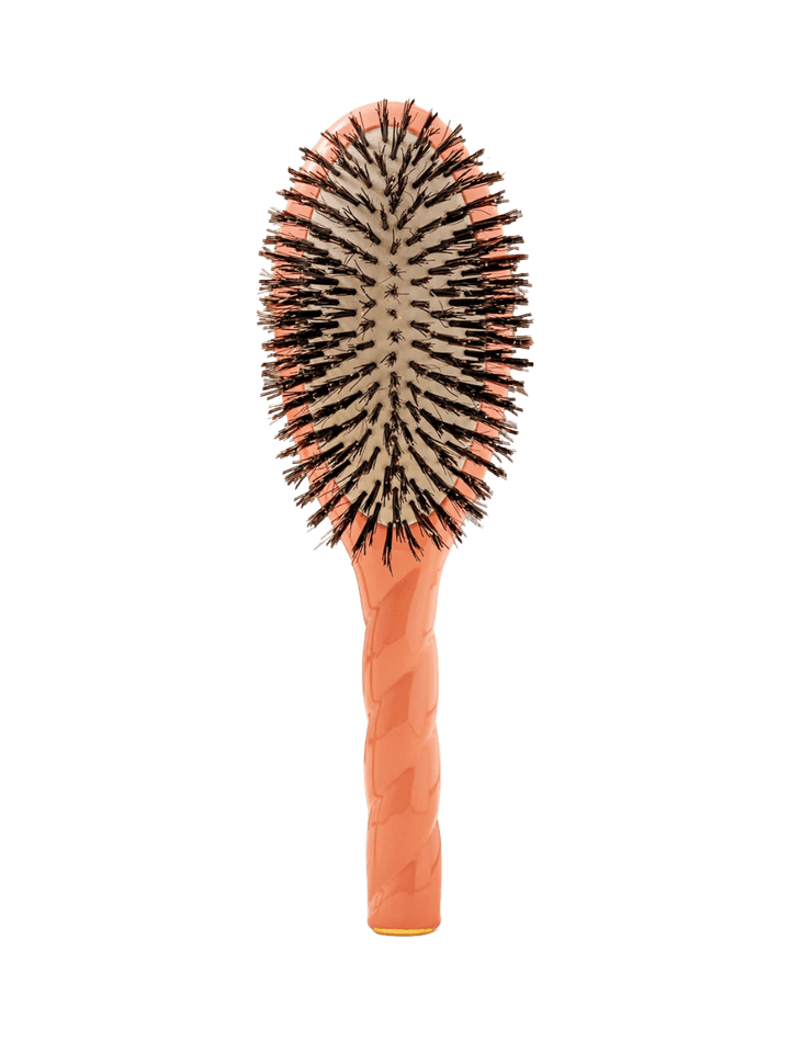 Front view of La Bonne Brosse N.01 The Shine & Care Hairbrush The Universal Brush in Orange Coral featuring a twisted ergonomic handle and natural boar bristles | Twentyseven Toronto