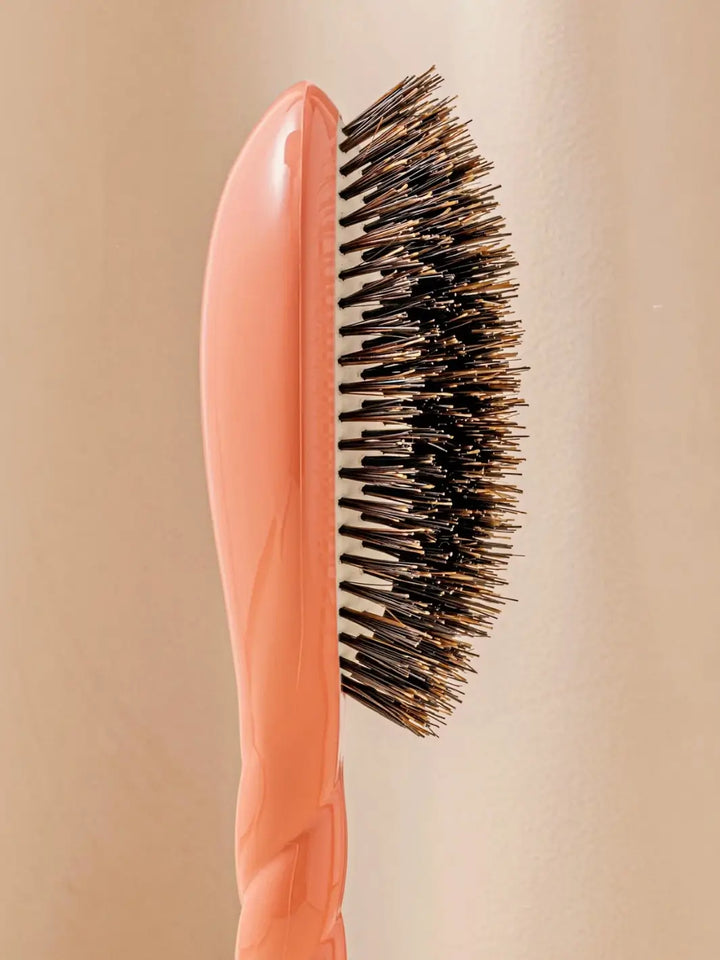 Close-up side profile shot highlights the tiered bristle design of La Bonne Brosse N.01 The Shine & Care Hairbrush The Universal Brush in Orange Coral | Twentyseven Toronto