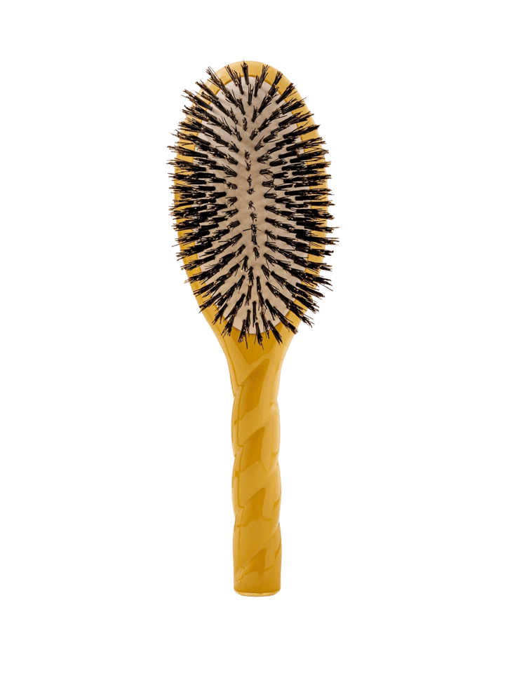 Front view of La Bonne Brosse N.01 The Shine & Care Hairbrush The Universal Brush in Saffron Yellow featuring a twisted ergonomic handle and natural boar bristles | Twentyseven Toronto