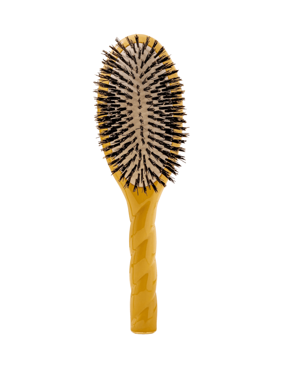 Front view of La Bonne Brosse N.01 The Shine & Care Hairbrush The Universal Brush in Saffron Yellow featuring a twisted ergonomic handle and natural boar bristles | Twentyseven Toronto