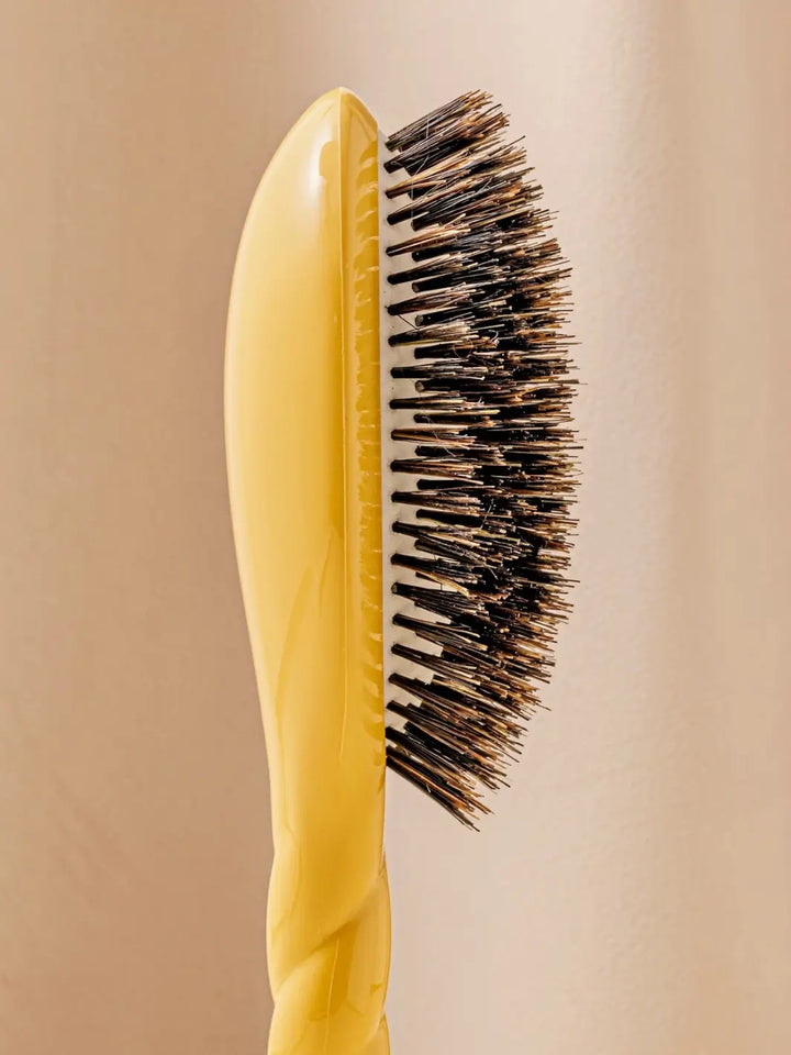 Close-up side profile shot highlights the tiered bristle design of La Bonne Brosse N.01 The Shine & Care Hairbrush The Universal Brush in Saffron Yellow | Twentyseven Toronto