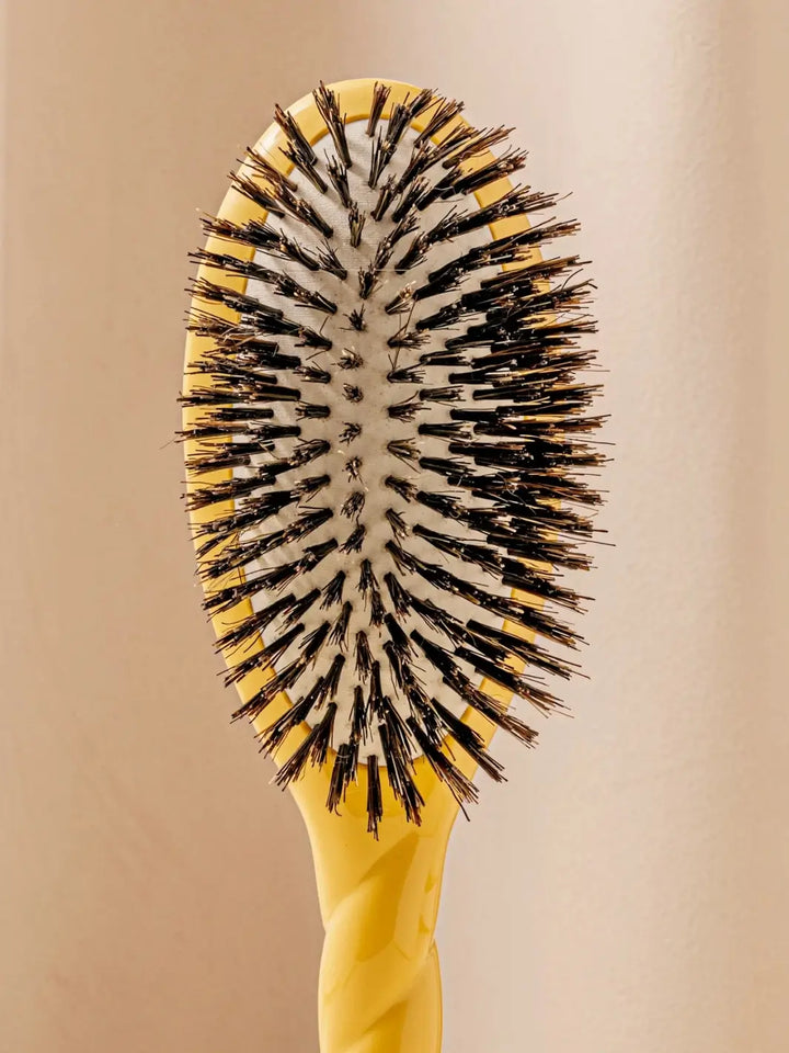 Front shot of the oval head and high-quality tufts of La Bonne Brosse N.01 The Shine & Care Hairbrush The Universal Brush in Saffron Yellow | Twentyseven Toronto