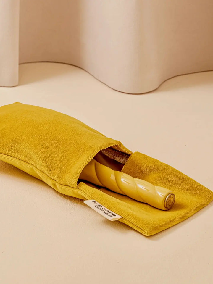 La Bonne Brosse N.01 The Shine & Care Hairbrush The Universal Brush in Orange Coral is partially tucked into a luxurious matching yellow velvet travel pouch | Twentyseven Toronto