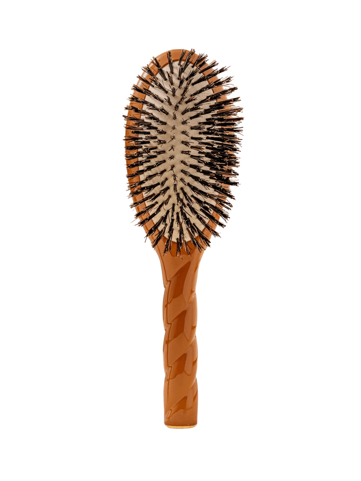 Front view of La Bonne Brosse N.01 The Shine & Care Hairbrush The Universal Brush in Terracotta featuring a twisted ergonomic handle and natural boar bristles | Twentyseven Toronto