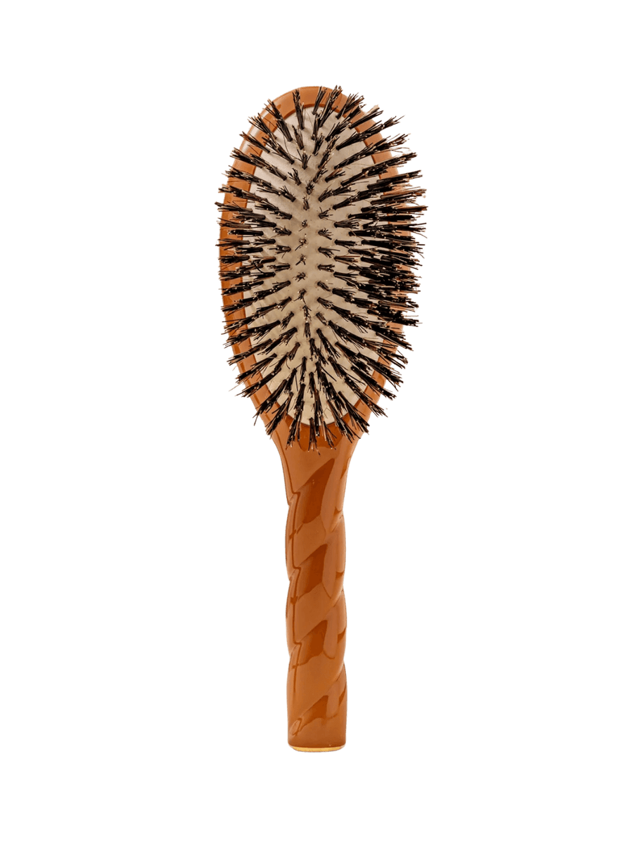 Front view of La Bonne Brosse N.01 The Shine & Care Hairbrush The Universal Brush in Terracotta featuring a twisted ergonomic handle and natural boar bristles | Twentyseven Toronto