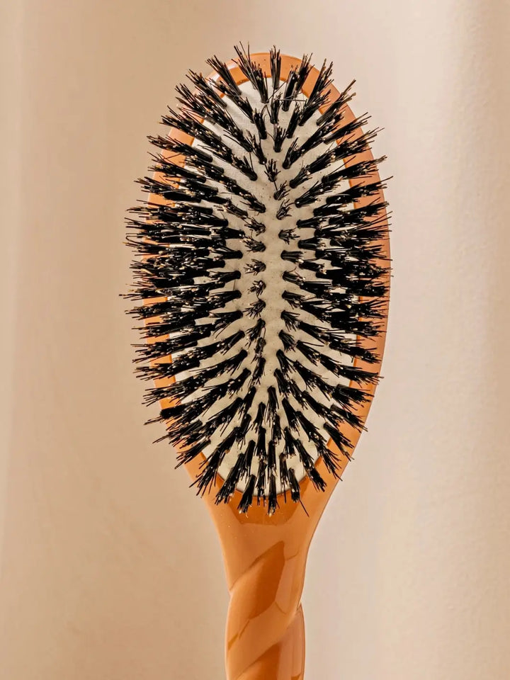Front shot of the oval head and high-quality tufts of La Bonne Brosse N.01 The Shine & Care Hairbrush The Universal Brush in Terracotta | Twentyseven Toronto